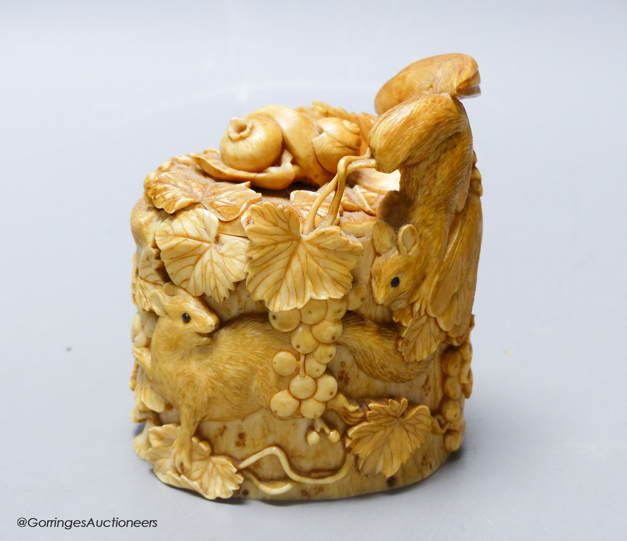 A Japanese ivory box carved with an eagle, frog and squirrels, Meijii period